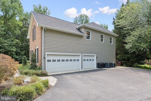 1508 Cornerstone Ct, Crownsville, MD 21032 - view of side of home featuring asphalt driveway, roof with shingles, and brick siding