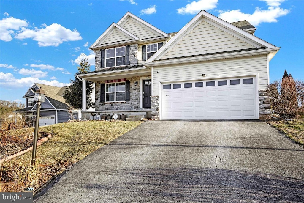 230 Joshua Dr, York, PA 17404 - traditional-style home with stone siding, driveway, and a garage