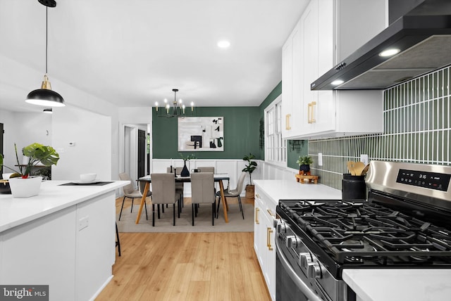 1013 Roxleigh Rd, Baltimore, MD 21286 - kitchen with stainless steel gas stove, wall chimney exhaust hood, white cabinetry, a chandelier, and recessed lighting