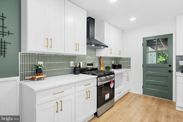 1013 Roxleigh Rd, Baltimore, MD 21286 - kitchen featuring stainless steel gas stove, wall chimney exhaust hood, tasteful backsplash, light wood finished floors, and recessed lighting