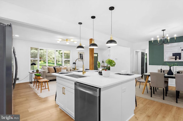 1013 Roxleigh Rd, Baltimore, MD 21286 - kitchen featuring stainless steel appliances, open floor plan, a chandelier, light wood-type flooring, and white cabinetry