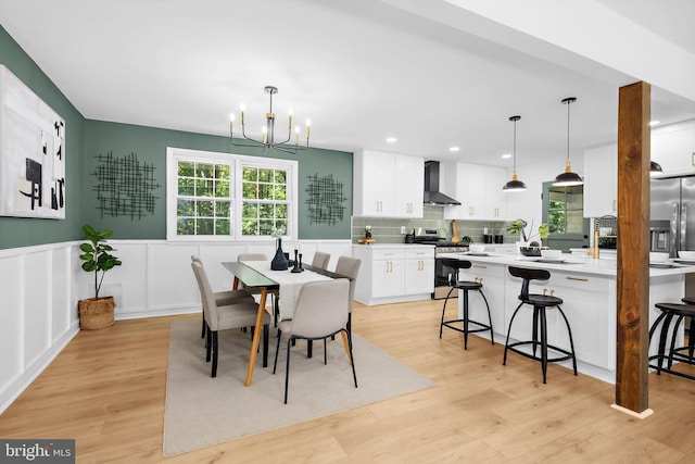 1013 Roxleigh Rd, Baltimore, MD 21286 - dining area featuring a chandelier, light wood-type flooring, wainscoting, recessed lighting, and a decorative wall