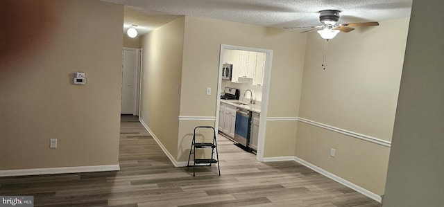 10725 W Dr Unit 301, Fairfax, VA 22030 - hallway with light wood-style floors and a textured ceiling