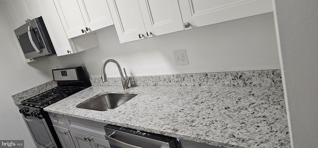 10725 W Dr Unit 301, Fairfax, VA 22030 - kitchen with appliances with stainless steel finishes, white cabinets, light stone countertops, and gray cabinets