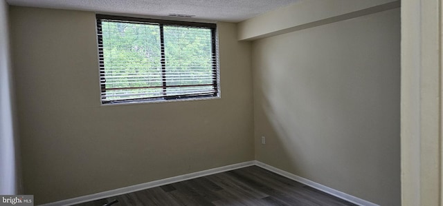 10725 W Dr Unit 301, Fairfax, VA 22030 - unfurnished room featuring a textured ceiling and dark wood-style flooring