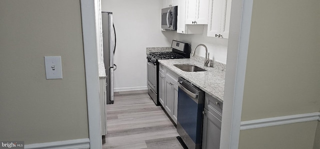 10725 W Dr Unit 301, Fairfax, VA 22030 - kitchen featuring stainless steel appliances, light stone countertops, and light wood-style flooring
