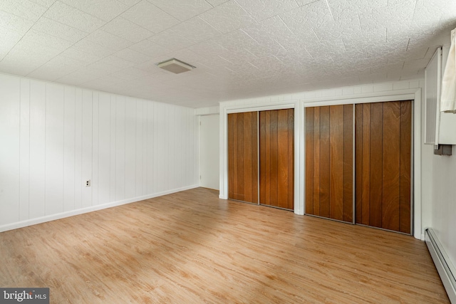 60 Ridge View Dr, Leola, PA 17540 - unfurnished bedroom with a baseboard heating unit, wood finished floors, and two closets