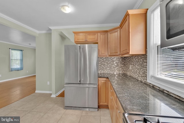 370 Nicholson Rd, Baltimore, MD 21221 - kitchen featuring freestanding refrigerator, ornamental molding, backsplash, light tile patterned flooring, and dark stone countertops