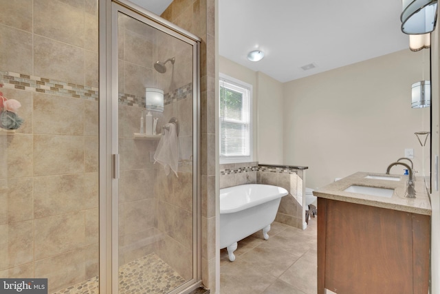 370 Nicholson Rd, Baltimore, MD 21221 - bathroom featuring a freestanding bath, a stall shower, tile patterned floors, double vanity, and tile walls