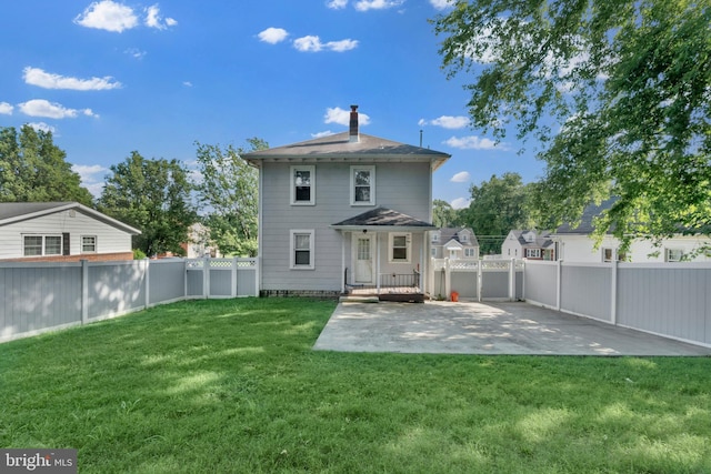 370 Nicholson Rd, Baltimore, MD 21221 - rear view of house with a fenced backyard, a patio area, and a chimney