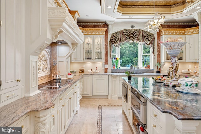 423 Seneca Rd, Great Falls, VA 22066 - kitchen featuring inlaid floor details, black electric stovetop, stone countertops, glass insert cabinets, and tasteful backsplash