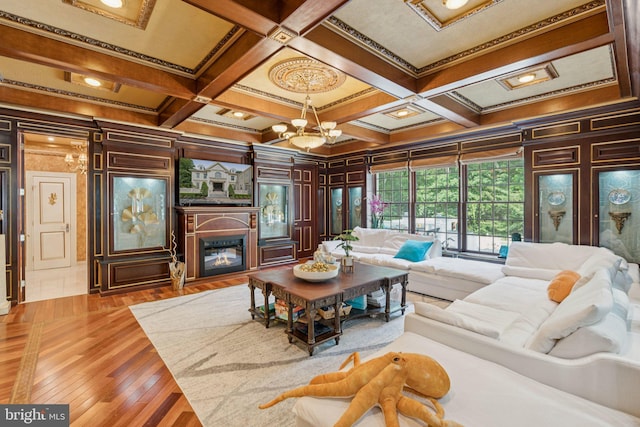 423 Seneca Rd, Great Falls, VA 22066 - living area with crown molding, coffered ceiling, beam ceiling, a chandelier, and a glass covered fireplace