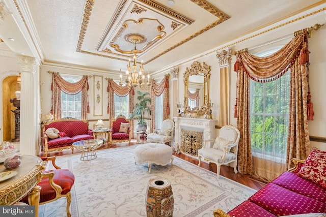 423 Seneca Rd, Great Falls, VA 22066 - sitting room with a raised ceiling, a chandelier, ornamental molding, decorative columns, and wood finished floors
