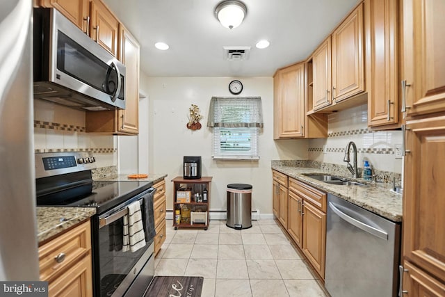 2205 Culpeper Dr, Woodbridge, VA 22191 - kitchen with appliances with stainless steel finishes, decorative backsplash, light stone counters, light tile patterned floors, and recessed lighting