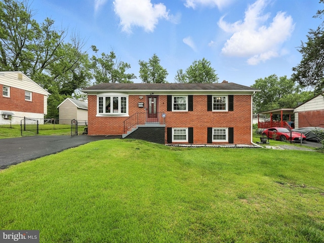2205 Culpeper Dr, Woodbridge, VA 22191 - view of front facade with brick siding, a gate, and asphalt driveway