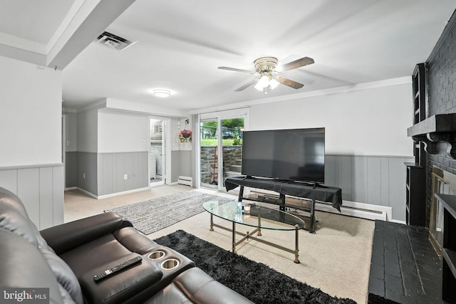 2205 Culpeper Dr, Woodbridge, VA 22191 - living area featuring a fireplace, wainscoting, ceiling fan, a baseboard heating unit, and carpet floors