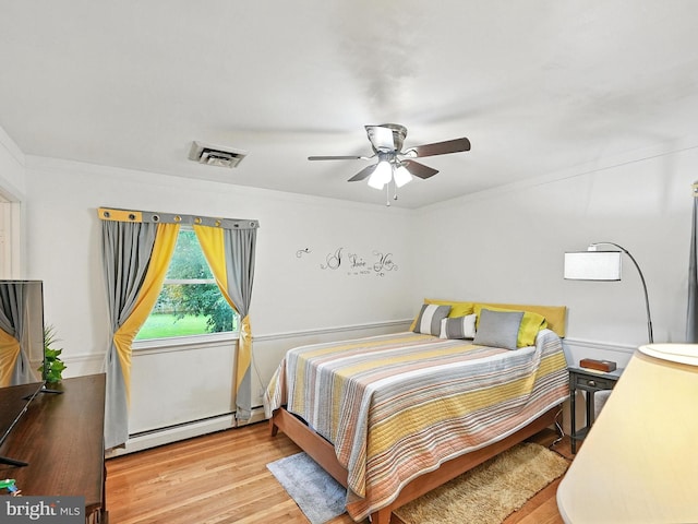 2205 Culpeper Dr, Woodbridge, VA 22191 - bedroom with a baseboard heating unit, wood finished floors, and a ceiling fan