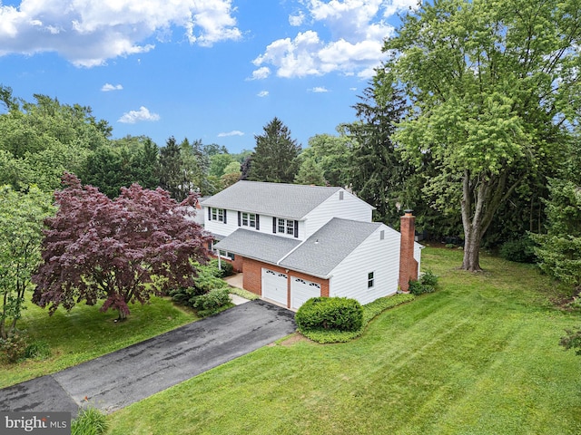 110 Wembley Rd, Wilmington, DE 19808 - view of front of property featuring driveway, roof with shingles, a garage, a front yard, and brick siding
