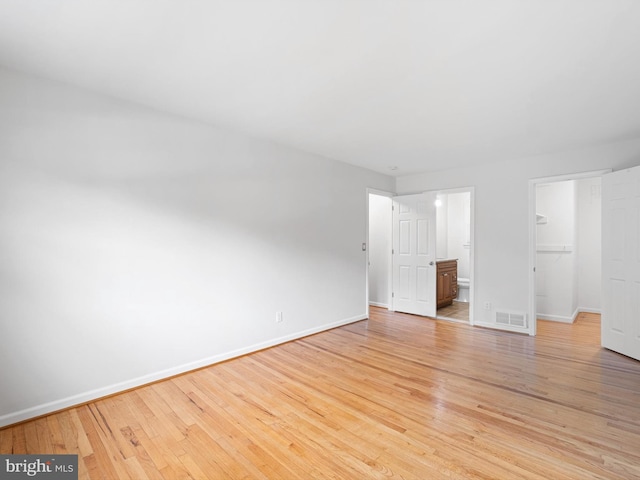 110 Wembley Rd, Wilmington, DE 19808 - unfurnished bedroom with a spacious closet, light wood-style floors, a closet, and ensuite bath