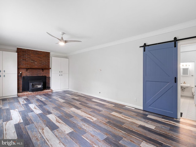 110 Wembley Rd, Wilmington, DE 19808 - unfurnished living room with wood finished floors, a ceiling fan, a barn door, ornamental molding, and a fireplace