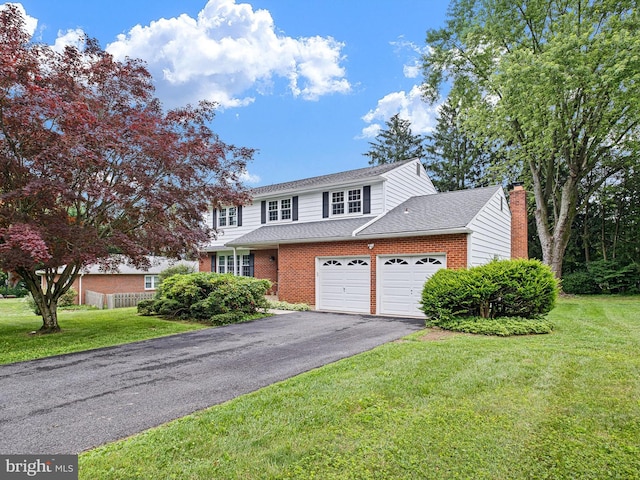 110 Wembley Rd, Wilmington, DE 19808 - traditional-style home featuring an attached garage, driveway, a front lawn, brick siding, and roof with shingles