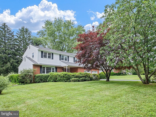 110 Wembley Rd, Wilmington, DE 19808 - view of front of property featuring brick siding, a front lawn, and a garage
