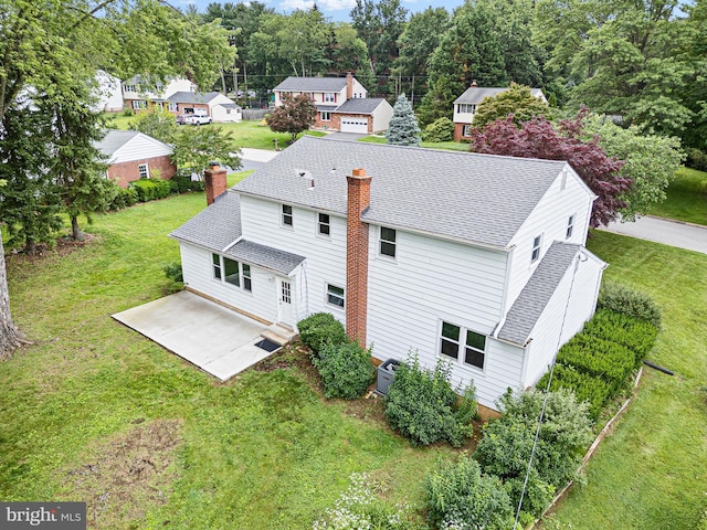 110 Wembley Rd, Wilmington, DE 19808 - back of house with roof with shingles, a chimney, and a lawn