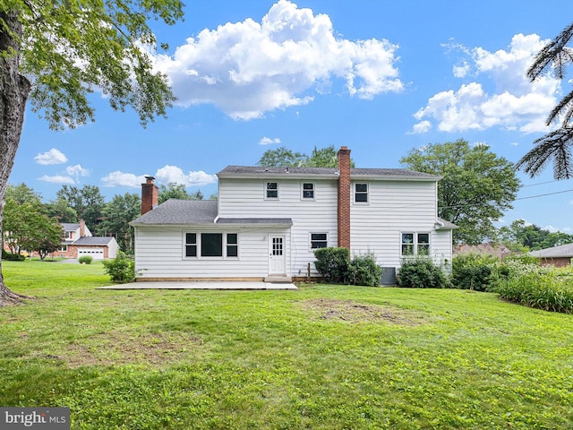 110 Wembley Rd, Wilmington, DE 19808 - rear view of house with a chimney, a lawn, and a patio area