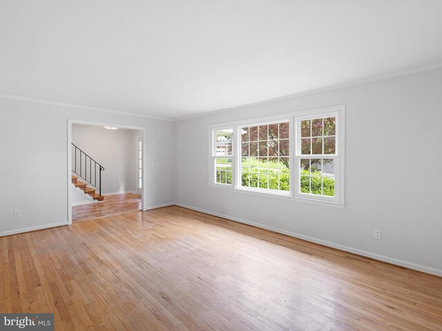 110 Wembley Rd, Wilmington, DE 19808 - spare room featuring stairway, light wood-style flooring, and ornamental molding
