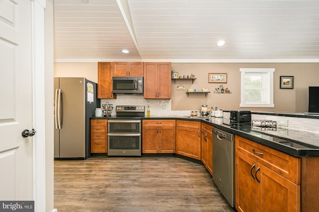 108 W Center St, Kitzmiller, MD 21538 - kitchen with appliances with stainless steel finishes, tasteful backsplash, dark countertops, a peninsula, and dark wood-type flooring