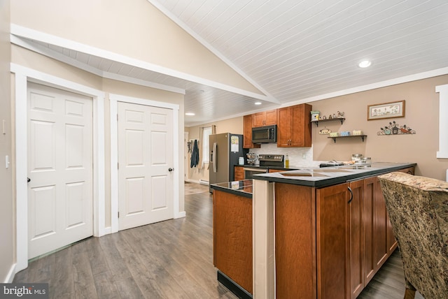 108 W Center St, Kitzmiller, MD 21538 - kitchen featuring appliances with stainless steel finishes, brown cabinetry, dark countertops, recessed lighting, and wood finished floors