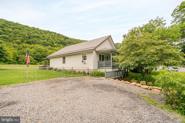 108 W Center St, Kitzmiller, MD 21538 - view of side of home with a metal roof, gravel driveway, and cooling unit