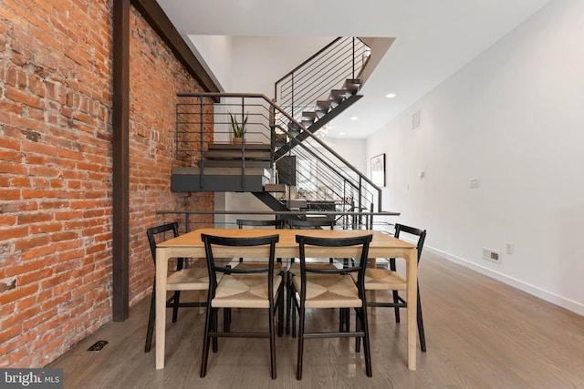2228 Carpenter St, Philadelphia, PA 19146 - dining space featuring stairway, wood finished floors, brick wall, and recessed lighting