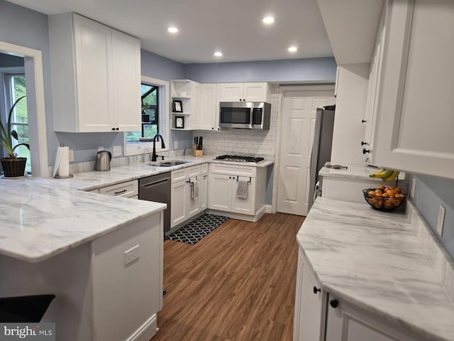 3902 Winchester Ln, Bowie, MD 20715 - kitchen featuring appliances with stainless steel finishes, white cabinetry, dark wood-type flooring, light stone countertops, and recessed lighting