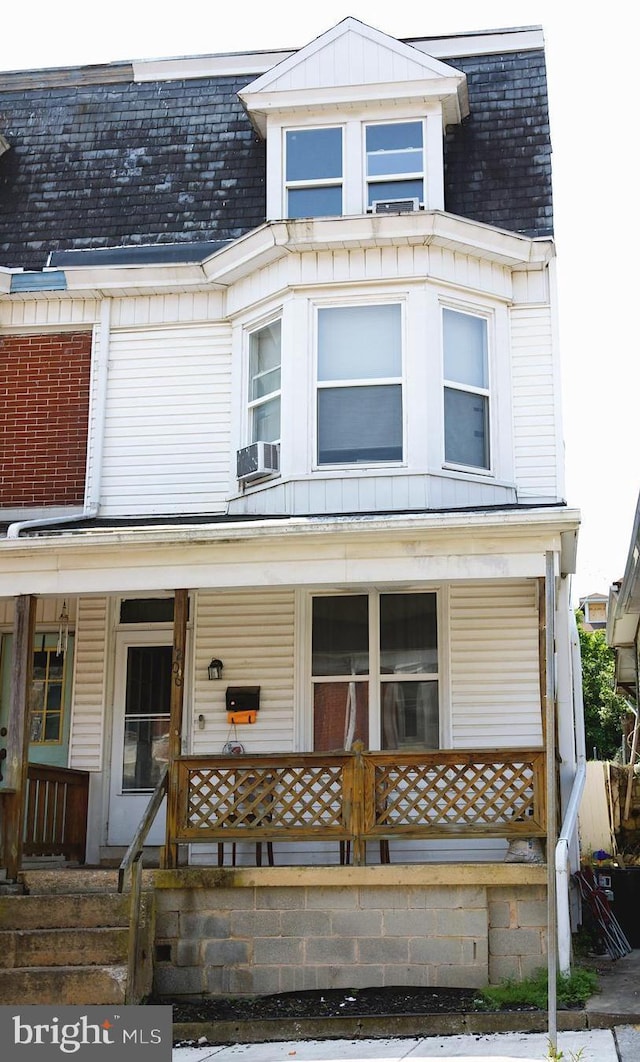 1206 W Poplar St, York, PA 17404 - view of front facade with a porch, cooling unit, and board and batten siding