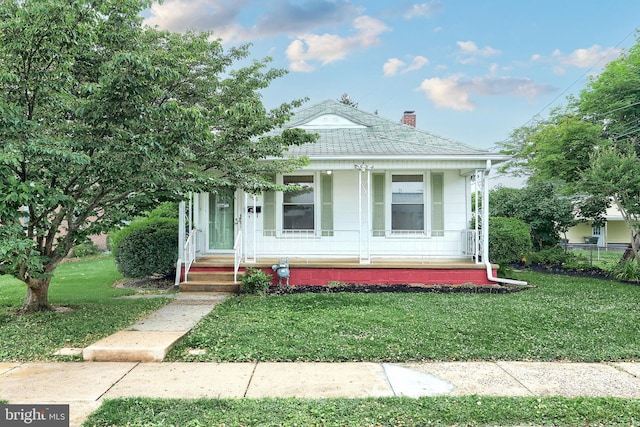 806 Pacific Ave, York, PA 17404 - view of front of property with a porch, a front lawn, a shingled roof, and a chimney