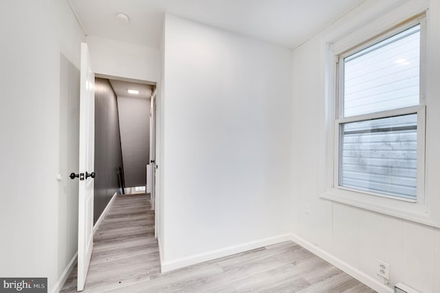 1354 Green St, Reading, PA 19604 - empty room with light wood finished floors, a baseboard heating unit, and a smoke detector