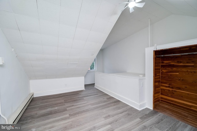 1354 Green St, Reading, PA 19604 - additional living space with a baseboard heating unit, wood finished floors, vaulted ceiling, and ceiling fan