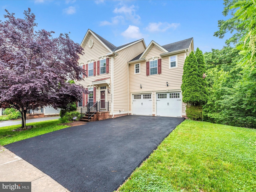 23032 Sycamore Farm Dr, Clarksburg, MD 20871 - view of front of home featuring asphalt driveway, a garage, and a front lawn