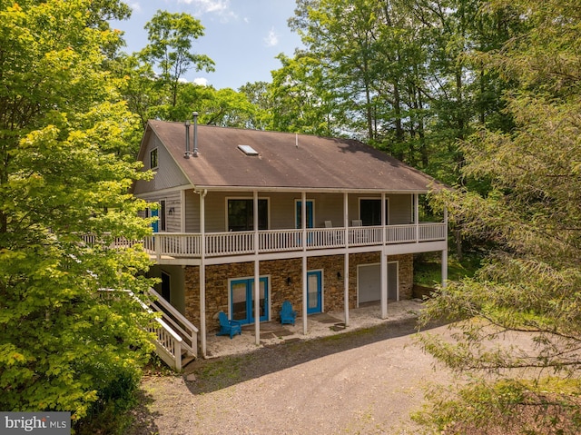 60 Barbaras Way, Mc Henry, MD 21541 - rear view of property with a garage, driveway, stone siding, a wooden deck, and roof with shingles