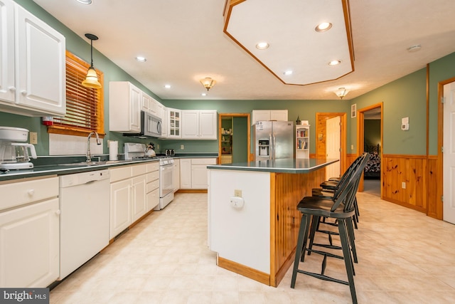60 Barbaras Way, Mc Henry, MD 21541 - kitchen featuring stainless steel appliances, dark countertops, a wainscoted wall, a kitchen island, and white cabinets