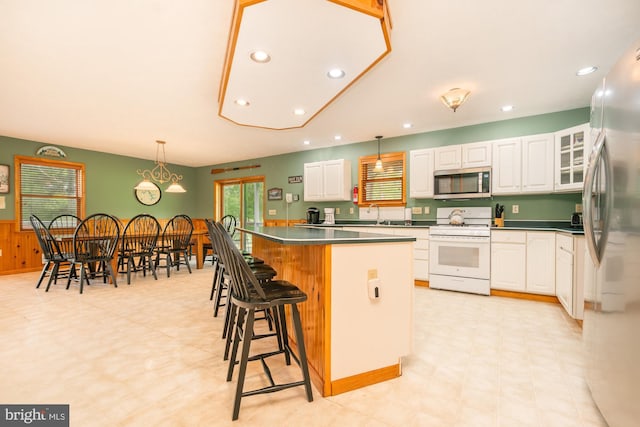 60 Barbaras Way, Mc Henry, MD 21541 - kitchen with stainless steel appliances, a center island, white cabinetry, a kitchen breakfast bar, and recessed lighting