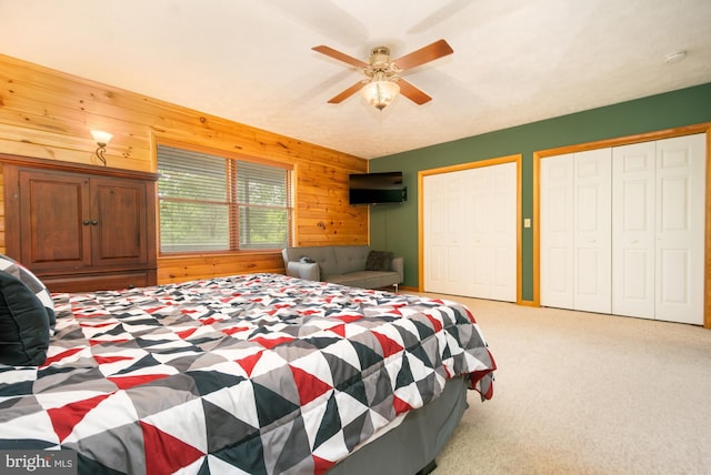 60 Barbaras Way, Mc Henry, MD 21541 - carpeted bedroom with wooden walls, two closets, and a ceiling fan
