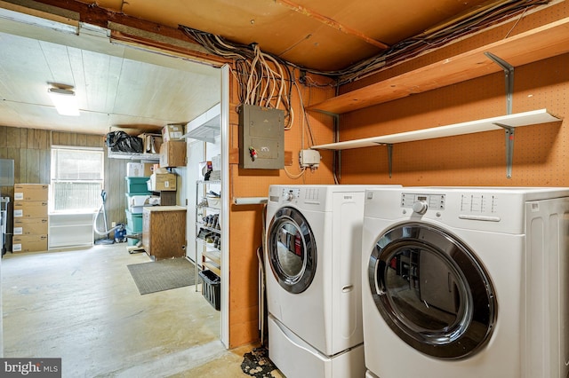 8615 Acorn Cir, Vienna, VA 22180 - laundry area with electric panel, washer and clothes dryer, and wooden walls