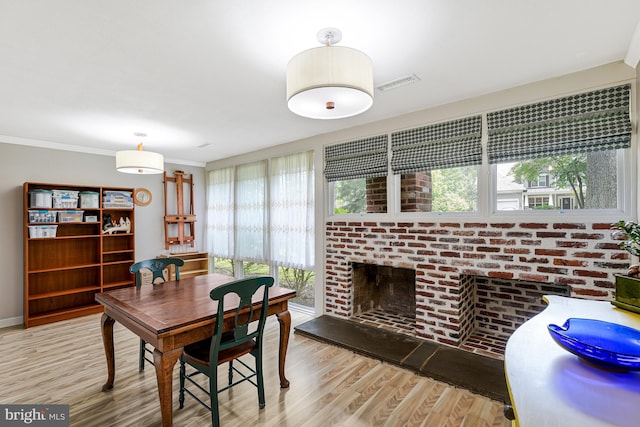 8615 Acorn Cir, Vienna, VA 22180 - dining room featuring plenty of natural light, wood finished floors, and a brick fireplace