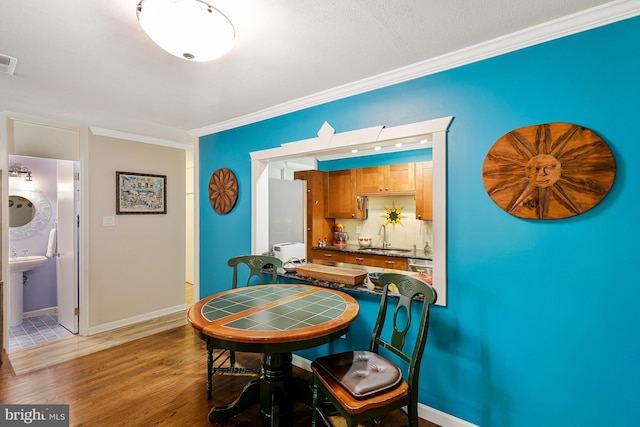 8615 Acorn Cir, Vienna, VA 22180 - dining room featuring crown molding and light wood finished floors