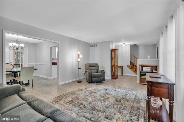 19 Oniontown Rd, Medford, NJ 08055 - living room with wood finished floors, stairway, and a chandelier