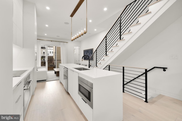 146 S St NW Unit B, Washington, DC 20001 - kitchen with modern cabinets, appliances with stainless steel finishes, light countertops, white cabinetry, and recessed lighting