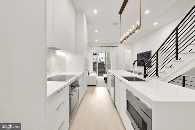 146 S St NW Unit B, Washington, DC 20001 - kitchen featuring modern cabinets, appliances with stainless steel finishes, recessed lighting, white cabinets, and hanging light fixtures