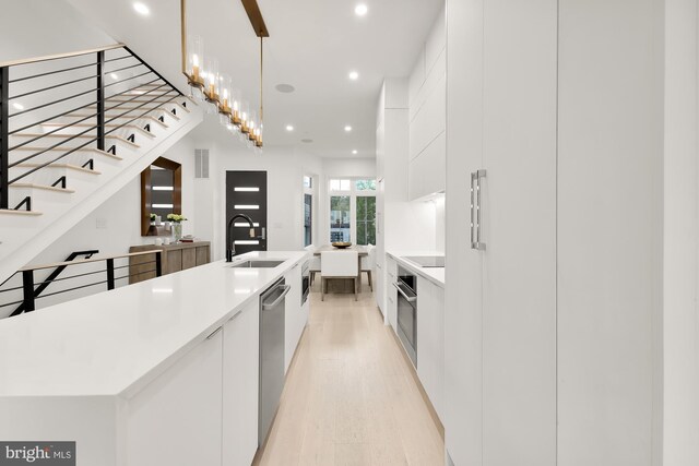 146 S St NW Unit B, Washington, DC 20001 - kitchen featuring modern cabinets, recessed lighting, appliances with stainless steel finishes, white cabinetry, and light wood-style flooring